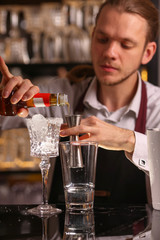 Margarita alcohol cocktail with lime ice. Alcohol cocktail on black background surface.  Barmen is making Margarita