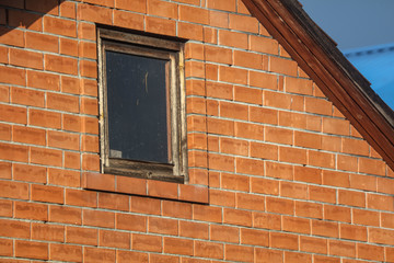 A window in a brick house under construction