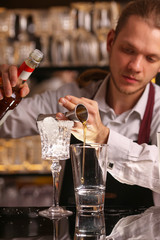 Margarita alcohol cocktail with lime ice. Alcohol cocktail on black background surface.  Barmen is making Margarita
