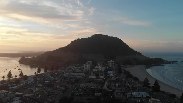 4k aerial mout manganui sunset camer dolly back