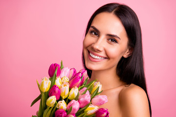 Close-up portrait of her she nice cute attractive lovely winsome charming feminine fascinating gentle cheerful brunette lady smelling colorful fresh natural flowers isolated on pink pastel background