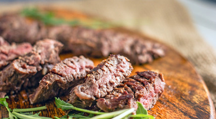 Beef Machete Steak. Grilled steak on a wooden board on a dark background. Delicious grilled meat, medium steak grilled, roast beef pieces
