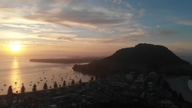 4k aerial mout manganui sunset camera dolly back