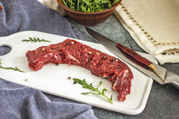 Raw beef fillet, veal tenderloin, meat for preparing steak and barbecue. Raw machete steak on a light background. Close up of beef meat