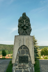 Fototapeta premium Sighisoara, Transylvania region, Romania - June 10, 2018: Ancient statue of Vlad Tepes and an old Dominican monastery