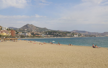 Fototapeta na wymiar sunny sandy beach mountains background