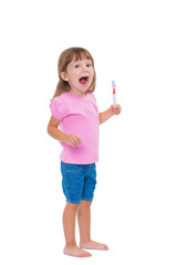Portrait of cute little girl 3 year old in pink t-shirt brushing her teeth isolated on white background