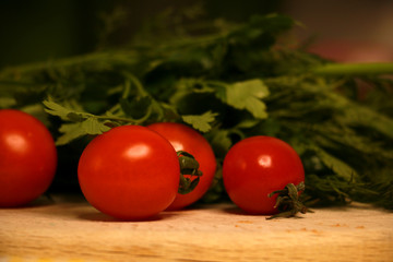 fresh red cherry tomatoes with green on the table