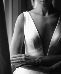 Bride's morning portrait. Bride dressed like a balerina stands before a bright window © IVASHstudio