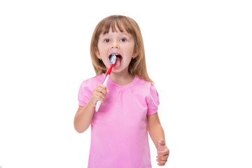 Close-up portrait Cute little girl 3 year old in pink t-shirt brushing her teeth isolated on white background