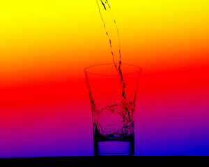 multicolored glass pouring clean water on a abstract background