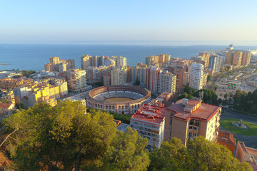 aerial view of the cityscape with the ancient bullring and the mediterranean sea