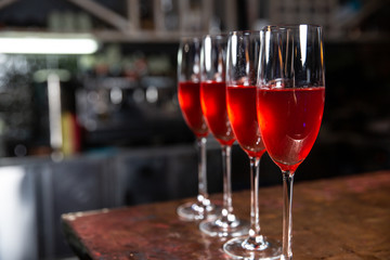 Beautifull Champagne glasses on table at restaurant background. Party with red champagne