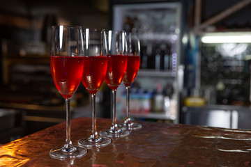 Beautifull Champagne glasses on table at restaurant background. Party with red champagne