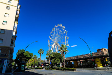 The Europe's largest itinerant ferris wheel named "La pricesa" the princess on the clear blue sky of Málaga 