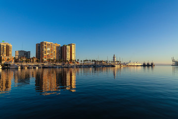 Skyline at the port of malaga with calm water