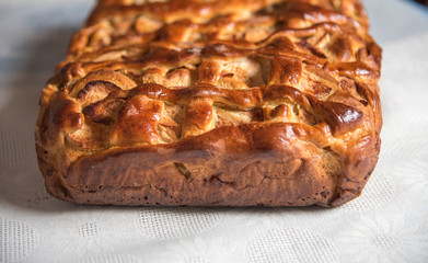 Freshly baked apple pie on the table close up