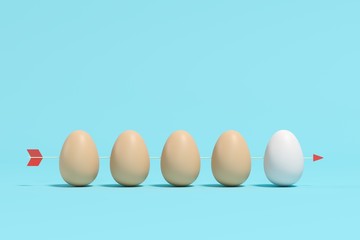White Egg among brown eggs with arrow on blue background. Minimal Easter Idea concept.