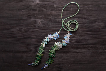 A multi-colored beads on a green rope