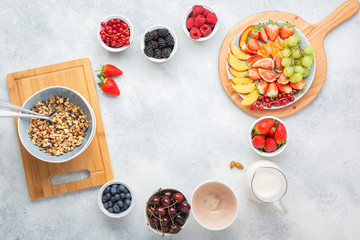 Raw vegan paleo granola made with nuts served with berries on white, top view, copy space