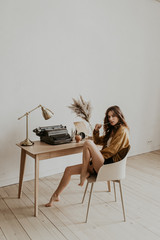 portrait of a beautiful girl writer in the workplace