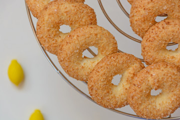 Circle cookies with small lemons on light background. Top view
