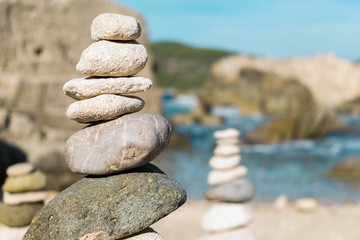 Pebble towers by the sea in a beach in Ibiza, Spain. 