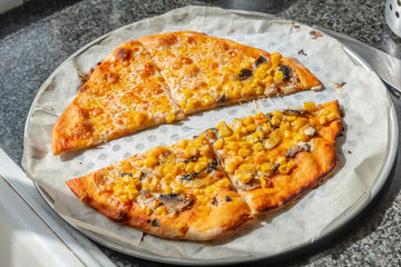 Homemade pizza with cheddar cheese and corn