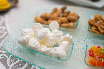 Fototapeta na wymiar Sweet marshmallow, walnuts and nuts
