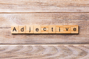 adjective word written on wood block. adjective text on wooden table for your desing, concept
