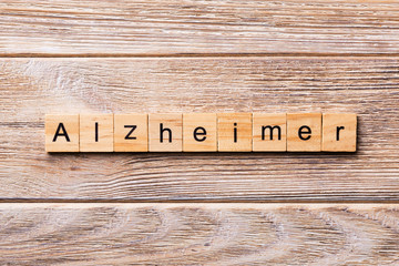 Alzheimer word written on wood block. Alzheimer text on wooden table for your desing, concept