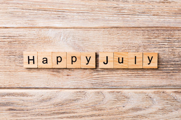Happy july word written on wood block. Happy july text on table, concept