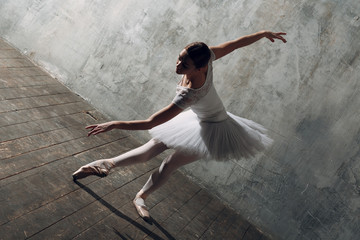 Ballerina female. Young beautiful woman ballet dancer, dressed in professional outfit, pointe shoes...
