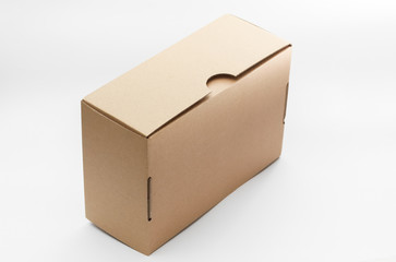 Closed empty cardboard box isolated on a white background