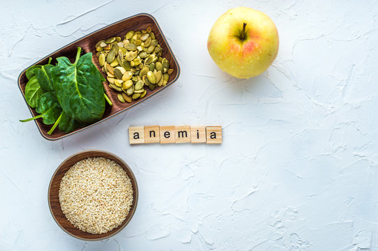 Spinach, pumpkin seeds, sesame, apple on a white background. Trace element FE. Close-up.