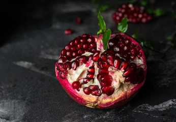 Ripe pomegranate fruit on black background. Vegetarian. Vitamin. Healthy food. Diet food.