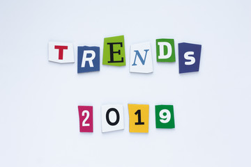 Obraz premium The word trends on colored letters. Trends concept. Inscription trends 2019. Abstract card with colored inscription text trends 2019 on white background for concept design. Text space. Aalphabet from 
