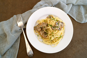 Spaghetti with mushrooms in cream sauce. on dark background