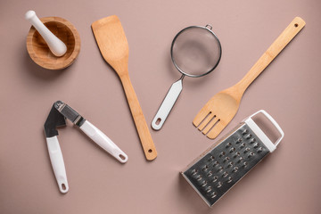 Set of kitchen utensils on color background