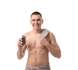 Fototapeta premium Handsome young man with deodorant on white background