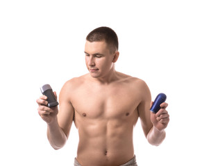 Fototapeta premium Young man with deodorants on white background