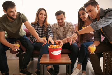 Group of friends eating nuggets at home
