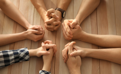 Group of people praying at table