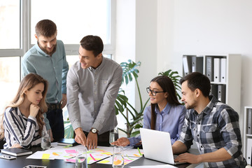 Group of people discussing business plan in office