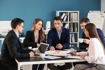 Group of people discussing business plan in office