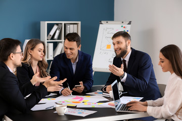 Group of people discussing business plan in office