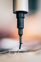 Macro detail view of screwdriver and screw in electronic service