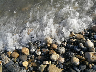 sea waves in summer on the pebble beach