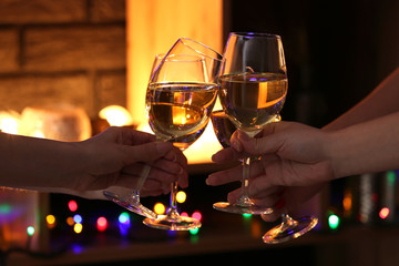 Women clinking glasses with tasty wine in bar