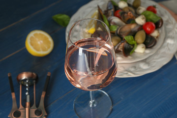 Glass of tasty wine on wooden table